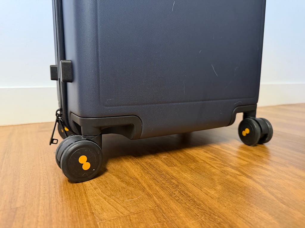 The ultra-quiet 360 degree wheels of the Luminous Textured Carry-On Suitcase