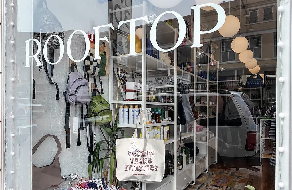 Fountain Square storefront with a "Protect Trans Hoosiers" bag prominently in the foreground