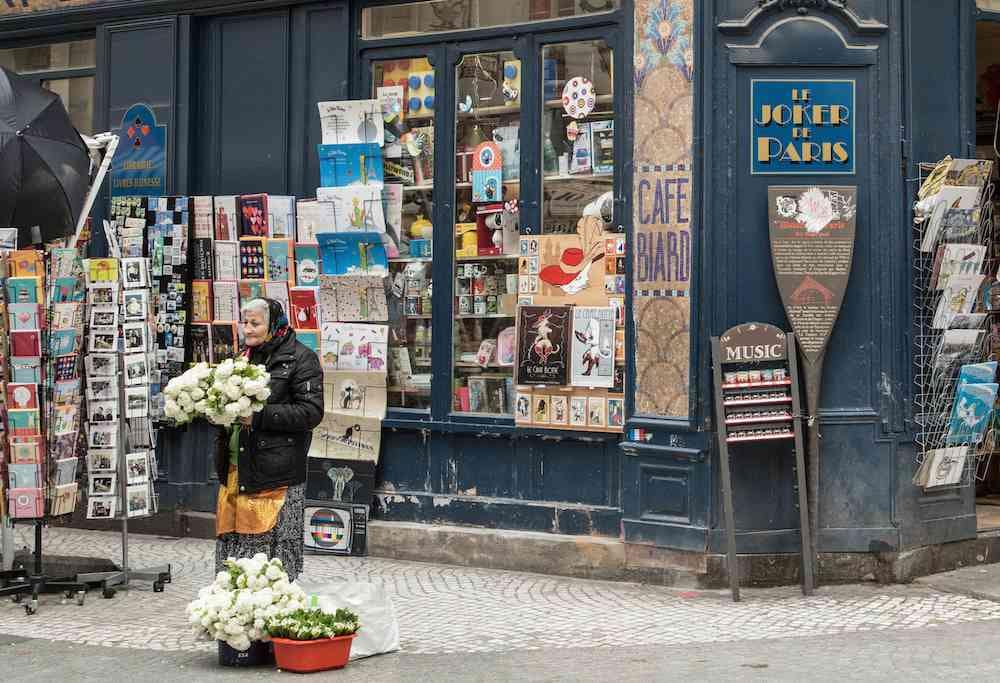 A female vendor on Rue Montorgueil selling flowers.