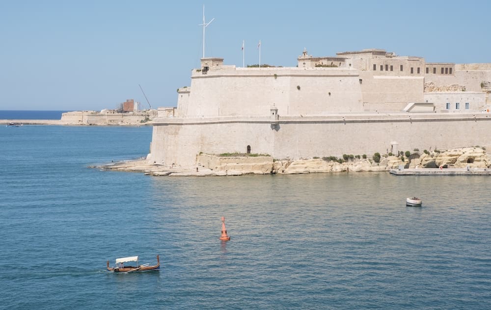 A Maltese boat passing by Fort St. Angelo