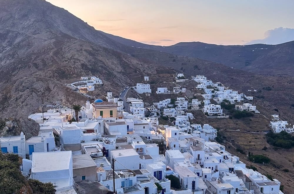 Sunset over the hills and the Chora (main town) of Serifos.