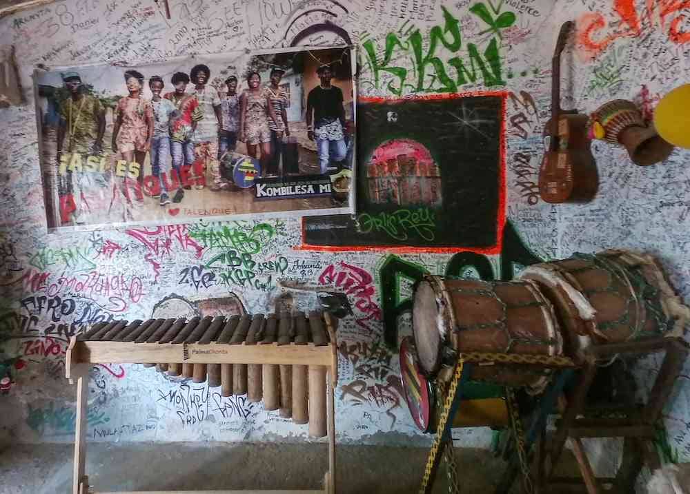 Musical instruments under a poster of Kombilesa Mi