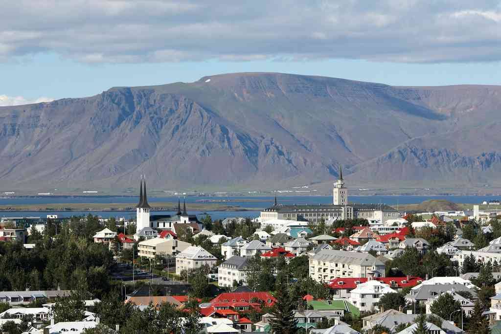 Reykjavik in front of mountains in the background.