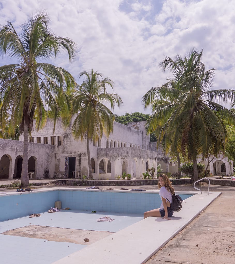 Sitting by the empty pool of Pablo Escobar's abandoned mansion in Isla Grande.